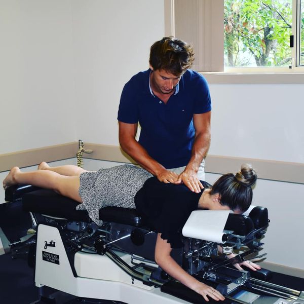 Chiropractor doing some chiropractic adjustment to the patient
