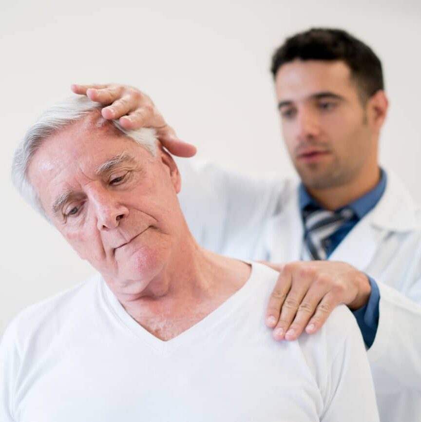 Old man is having a chiropractic adjustment with a chiropractor