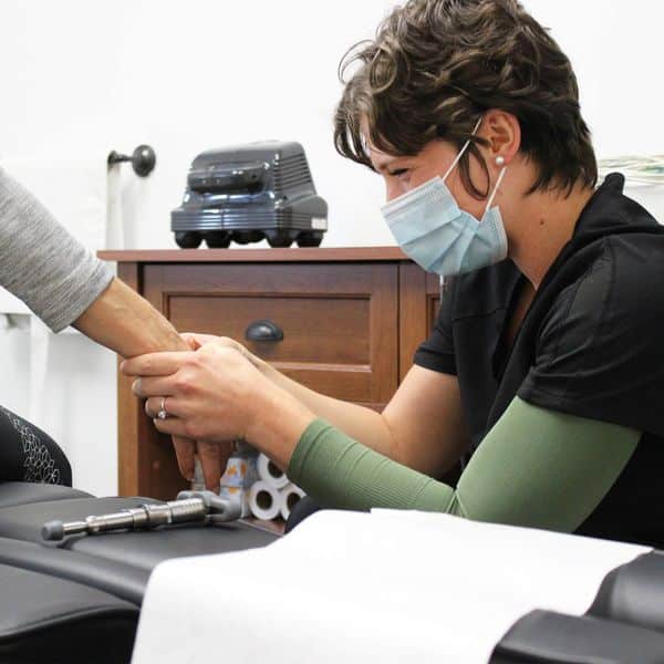 Chiropractor is treating the hand of the patient
