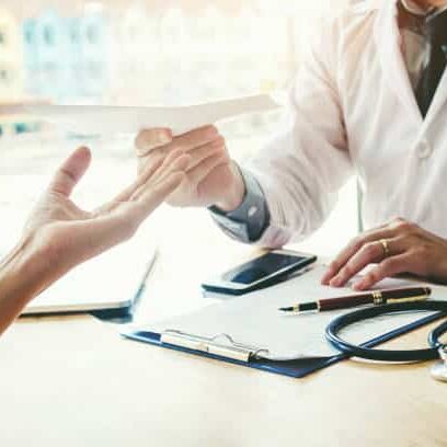 Patient is handling her health insurance information to the physician