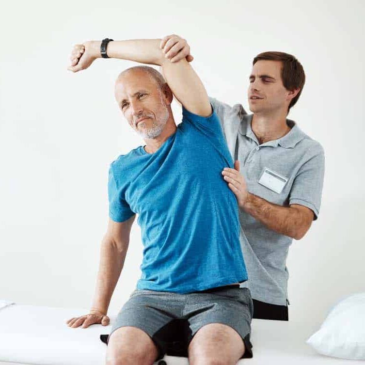 physiotherapist evaluating a patients body.