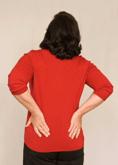 Middle aged woman suffers from lower back pian and arthritis.