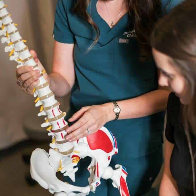 Chiropractor explaining what is Herniated Disc to the patient