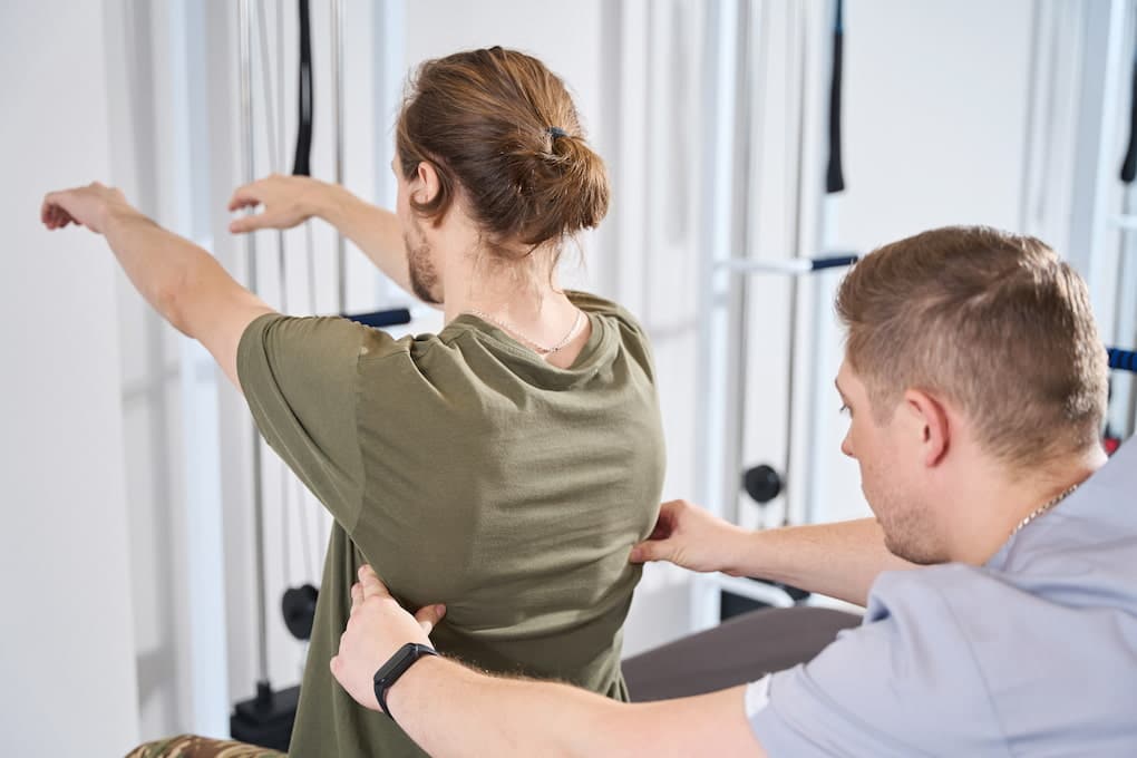 man getting examined by chiropractor after going through surgery