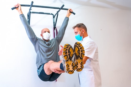 Healthcare professional assisting a patient with rehabilitation