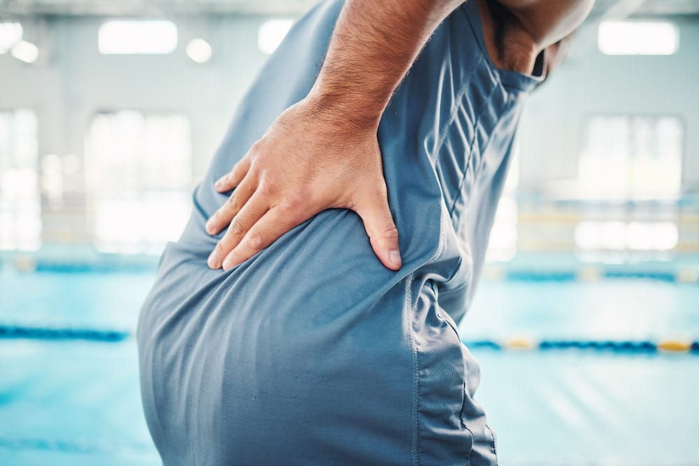 man enduring buttocks pain and Piriformis Syndrome symptoms 